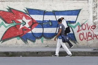 People walk past a mural with the Cuban flag in Havana, Cuba, on April 15. Photo: EPA