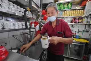 财顺咖啡摊的员工付子同（75岁）平日午餐时段总是忙得不可开交，但这几天较空闲，因此有时间和记者交谈。（唐家鸿摄）