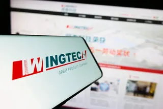 A smartphone displays the Wingtech logo in front of the company’s website. Photo: Shutterstock