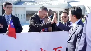 Taiwanese President high-fiving man in suit