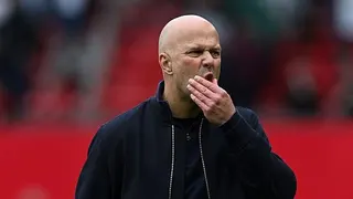 Arne Slot strokes his chin during the defeat to Manchester United