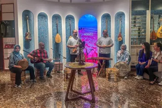 Majid and Massoud Shamaeezadah (standing) hold a concert at their music workshop in Beijing. Photo: Laura Zhou
