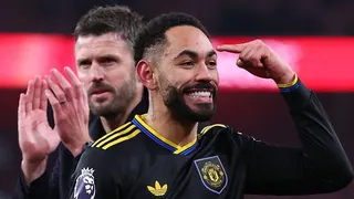 Matheus Cunha points to his head with Michael Carrick applauding behind him