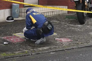 A police officer investigates the scene where a high school student was struck on the head with a hammer by a man in Fussa, western Tokyo, on Wednesday. Photo: Kyodo