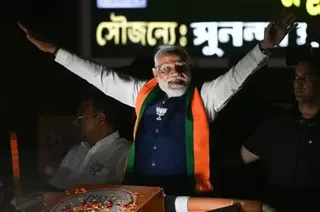 Hindustan Times via Getty Images Prime Minister Narendra Modi during a road show in support of BJP candidates ahead of 2nd phase of West Bengal Assembly Election