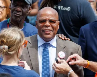 a man smiles while surrounded by people