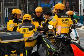 A group of delivery riders for the Chinese online platform Meituan takes a break in Chongqing, southwest China. Photo: Getty Images