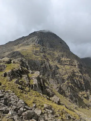 A view of a mountain peak touching cloud in Eryri.