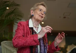 Robinson gesticulating as she speaks