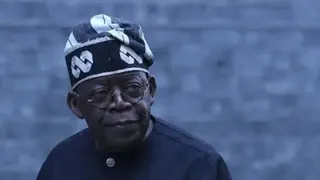 Anadolu via Getty Images Nigeria’s president Bola Tinubu wearing glasses, his trademark traditional hat and a dark gown