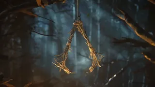 A totem made from sticks shaped like the Assassin's Creed logo in the short teaser for Hexe