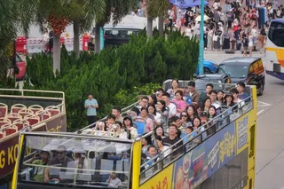 Tourists ride in an open-top bus in Central during the Labour Day holiday. Authorities expect about 980,000 mainland Chinese visitors to come to Hong Kong for the break. Photo: Elson Li