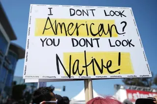 A sign at an anti-racism rally. A new survey highlights the ongoing harassment faced by Asian-Americans. Photo: Getty Images