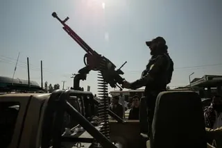 A Taliban security member rides an armed vehicle on the outskirts of Jalalabad