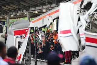Workers and rescuers on Tuesday examine the wreckage following a train collision in Bekasi, Indonesia. Photo: AP