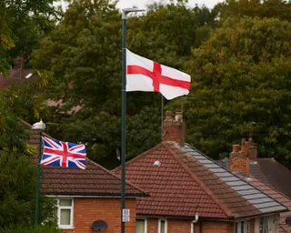 A union jack and St George's flag fly on two lamp-posts.
