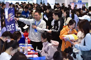 University students attend a job fair in Fuyang, Anhui province, on April 28. Photo: CN-STR / AFP