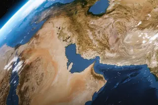 A high-angle satellite view showing the Strait of Hormuz, the Persian Gulf, and the rugged desert topography of the Middle East. Photo: Getty Images