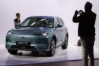 A journalist takes pictures of the Geely E5 electric compact SUV car presented at the launch of Geely Auto France in Paris on April 28. Photo: Reuters