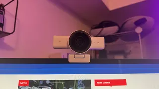 The Razer Kiyo V2 X webcam on top of a monitor, showing the PC Gamer home page