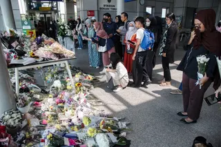On Friday, people offer flowers and pray for the victims of a Monday train collision that killed 16 people at Bekasi Timur Station in Bekasi, West Java. Photo: AFP
