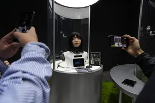 Visitors take pictures and videos of a human-like robot head on display at the Humanoid Robots Industry Base in Beijing’s Shougang Park on April 28. Photo: AP
