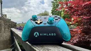 The GameSir G7 Pro 8K Aimlabs Edition on its dock on wood, outside