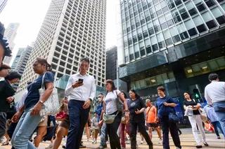 People cross a street in Central on October 20, 2025. Photo: Jonathan Wong