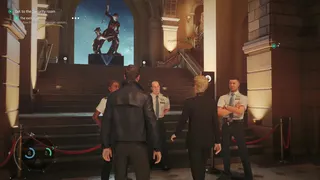 007 First Light screenshot showing Bond being escorted past security with a PR woman