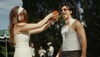 Laufey/Vingolf/Awal Laufey and Hudson Williams play with a prop fish on the set of her music video for Mad Woman