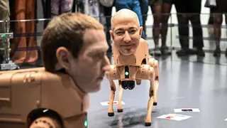 Two dog-like robots with the heads of Mark Zuckerberg and Jeff Bezos