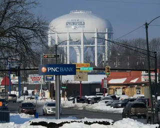 a water tower rises above a city