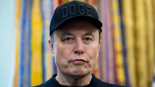 Elon Musk, chief executive officer of Tesla Inc., wears a "DOGE" hat during a news conference in the Oval Office of the White House in Washington, DC, US, on Friday, May 30, 2025.