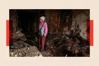 Reuters A woman dressed in pink inspects the ruins after a Russian attack on Ukraine