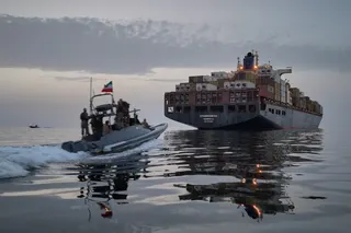 An Iranian Revolutionary Guard Navy speedboat approaches the cargo ship Epaminondas during what state media described as the seizure of one of two vessels accused of violations in the Strait of Hormuz on April 21. Photo: Tasnim News Agency via AP