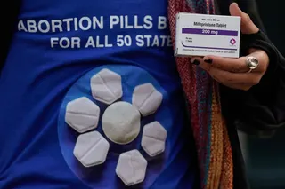 A pro-abortion rights activist holds a box of mifepristone during a rally in front of the US Supreme Court in 2024. Photo: AFP
