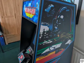 Image may contain Arcade Game Machine Game Adult Person Computer Hardware Electronics Hardware Monitor and Screen