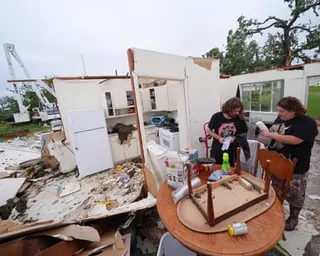 People sift through remains of homes ripped apart by storm