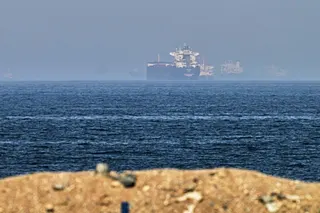 Cargo ships at sea near the Strait of Hormuz, as viewed from a rocky shoreline near Khor Fakkan, United Arab Emirates. Photo: AP