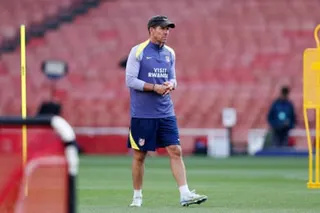 Atlético Madrid manager Diego Simeone watches his players train at the Emirates Stadium on Monday