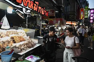 A customer orders grilled seafood from a street vendor in Bangkok’s Chinatown, Thailand, on Wednesday. Photo: AFP