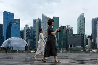 People walk on the boardwalk in front of Singapore’s financial centre. Photo: AFP