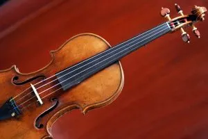 Violin against a red background.