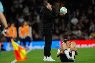 Roberto De Zerbi holds out the ball