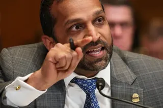 a man points while speaking into a microphone
