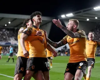 Hull players rush to Mohamed Belloumi after the substitute opens the scoring against Millwall.