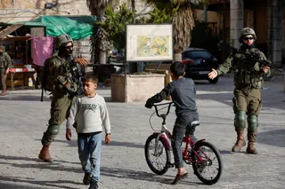 Israeli soldiers direct Palestinian children to disperse during a weekly settlers’ tour in Hebron, in the Israeli-occupied West Bank, May 9, 2026. — Reuters pic