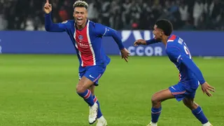 PSG's Desire Doue, left, celebrates scoring his side's opening goal during the French League One soccer match between Paris Saint-Germain and Brest in Paris, France, Sunday, May 10, 2026