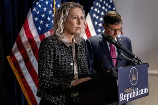 a woman speaks into a microphone