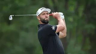 jon rahm swinging an iron
